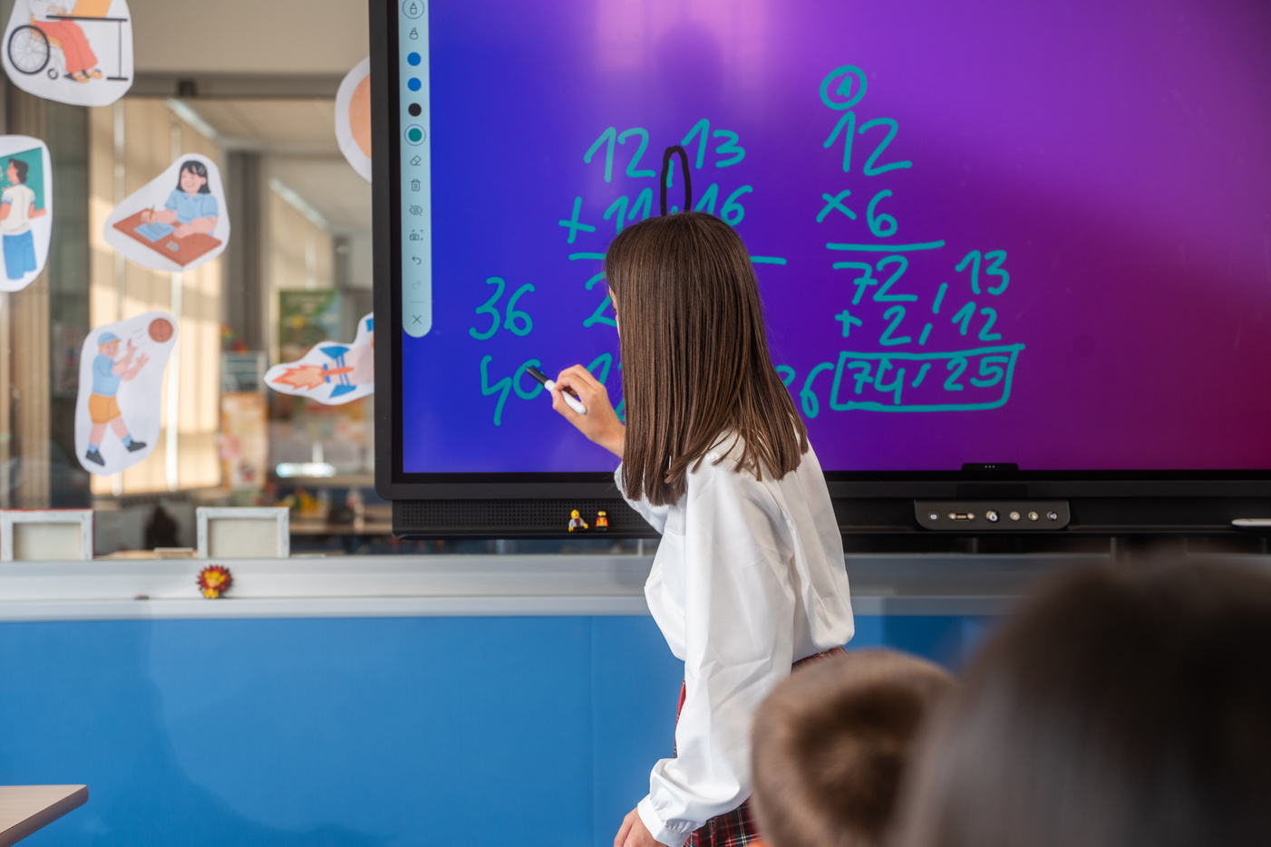 Student Writing on Interactive Board